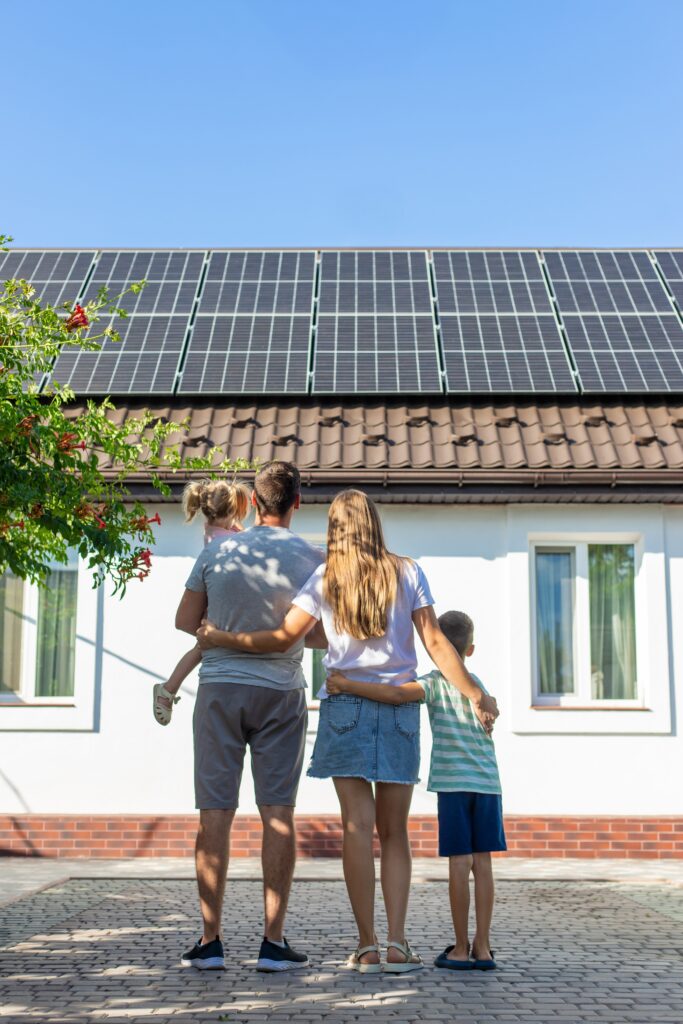 happy,family,on,the,background,of,a,house,with,solar